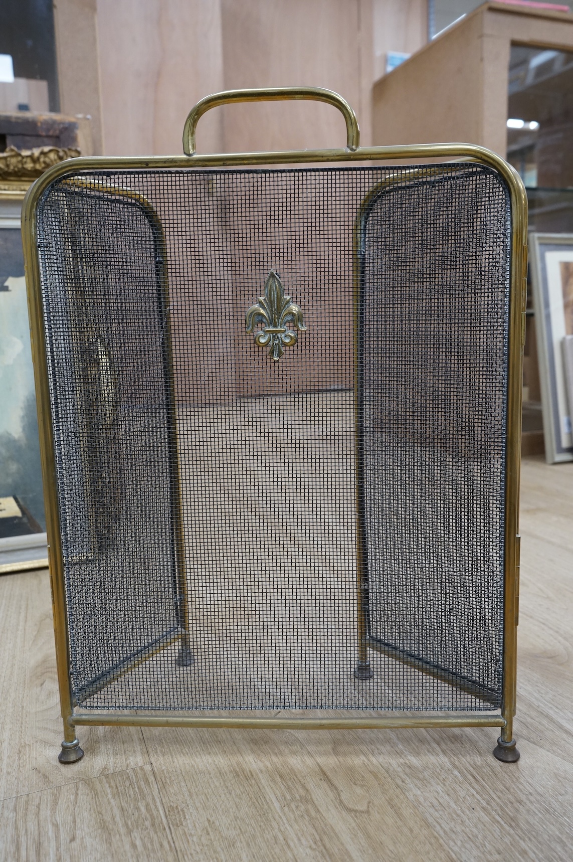 A fire brass guard, pair of candlesticks, kettle, miner's lamp etc, fire guard 54cm high.